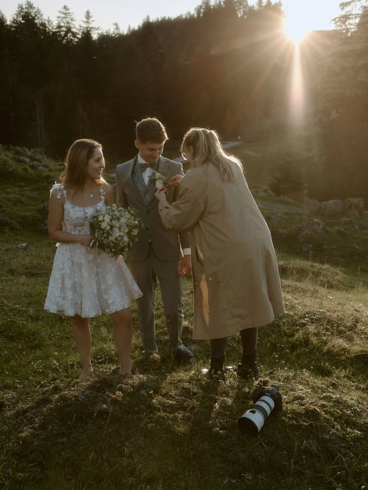 a woman helps a groom with the flowers